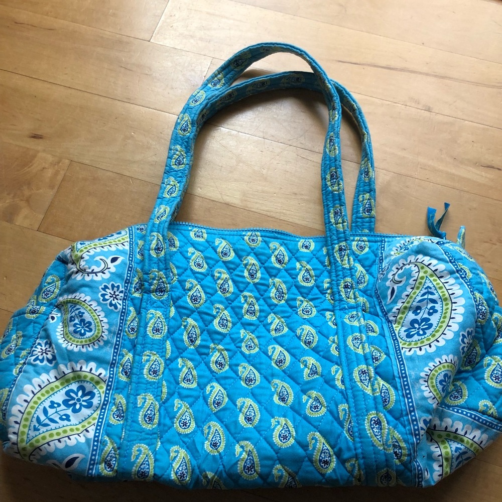Iconic small duffel in blue and green tones